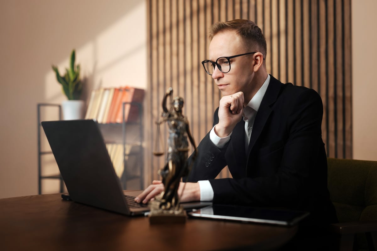 Lawyer analyzing legal documents at an office desk